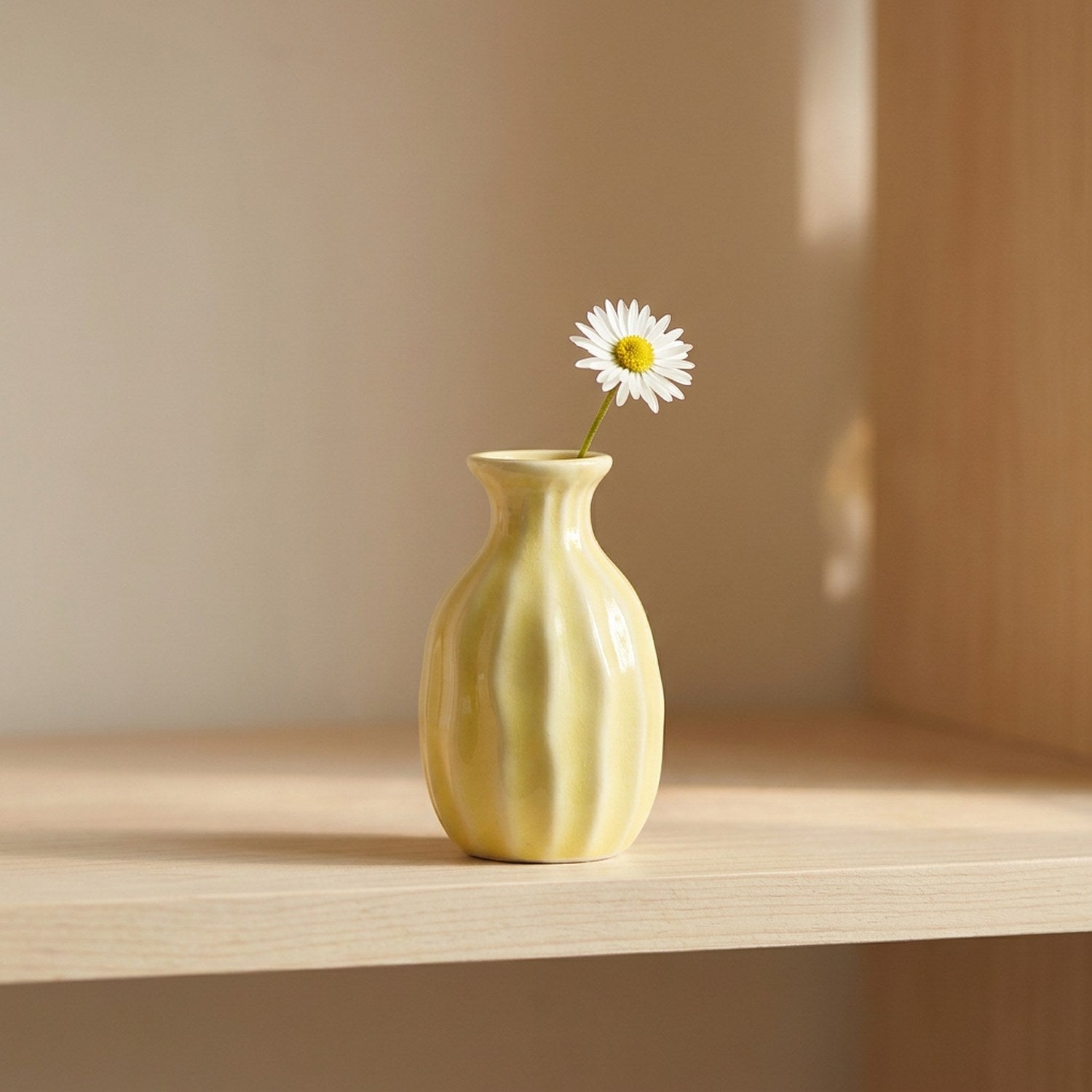 Vase soliflore en céramique côtelé jaune pastel avec une fleur unique