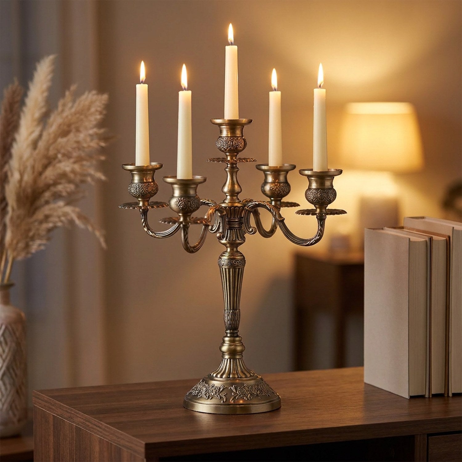 Chandelier en métal bronze avec bougies allumées sur une console en bois le soir