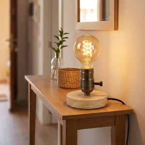 Lampe de table en bois avec douille bronze vintage sur une console d'entrée