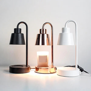 Lampe chauffe-bougie en trois coloris noir doré et blanc allumée avec bougies parfumées