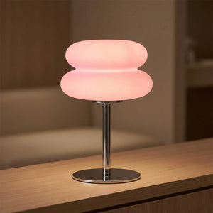 Lampe de chevet galet coloris rose allumée
