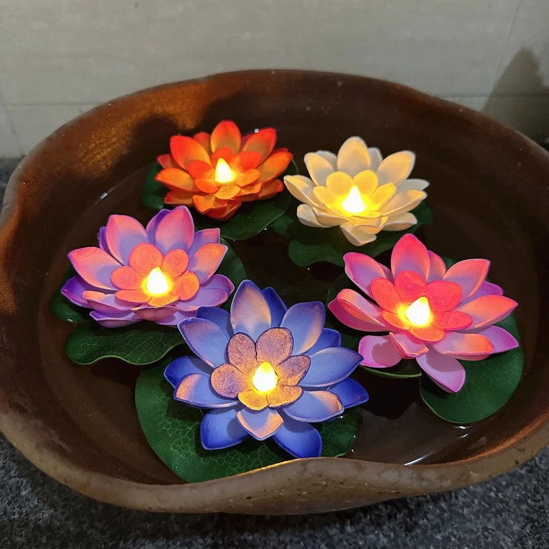 Lampes lotus flottantes LED allumees dans un bol en bois rempli d eau