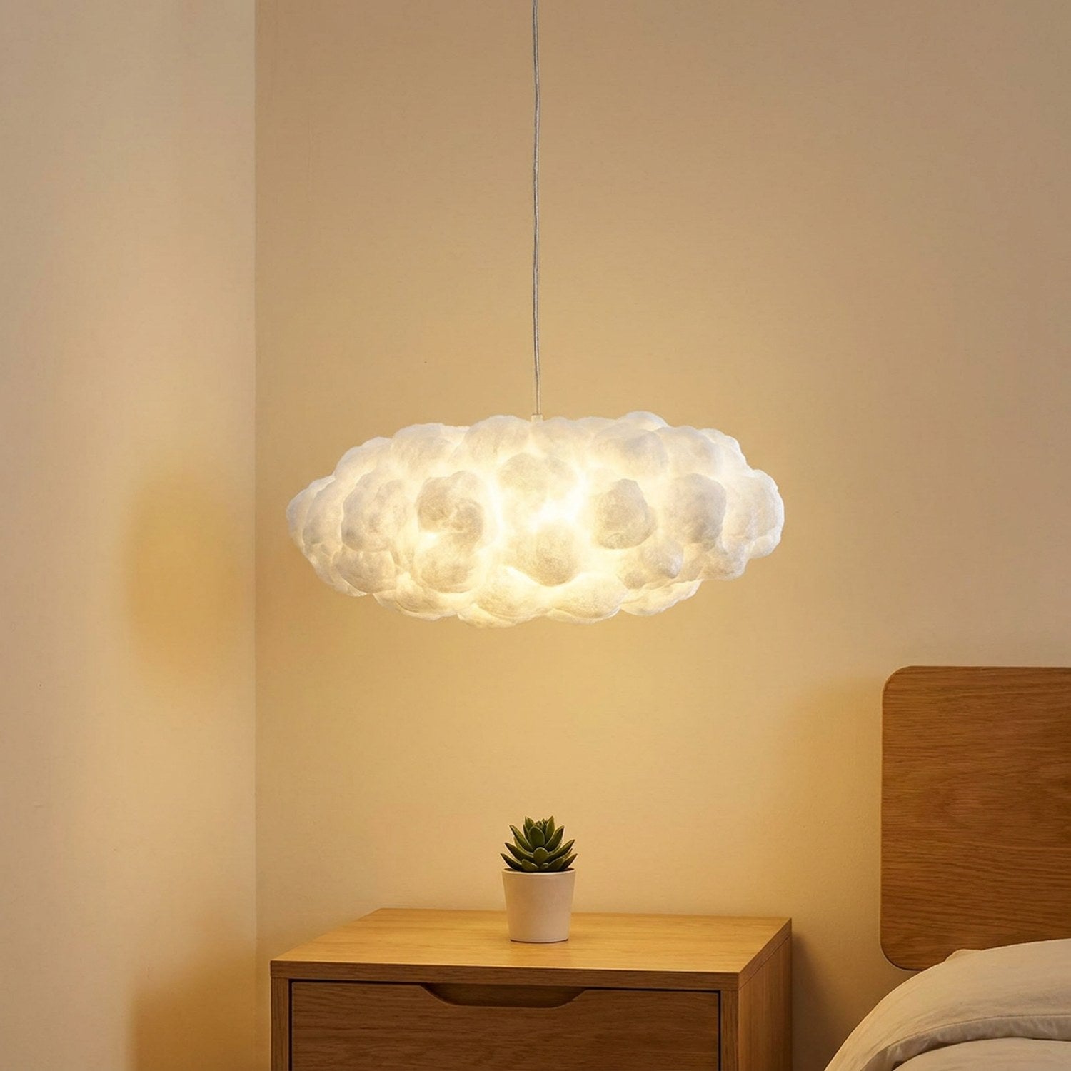 Lampe nuage suspendue 30-40 cm au-dessus d'une table de nuit bois dans une chambre cosy
