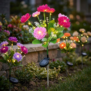 Lampes solaires de jardin a fleurs de plusieurs couleurs dans un parterre