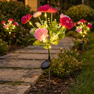 Rangee de lampes solaires a fleurs le long d un chemin de jardin la nuit