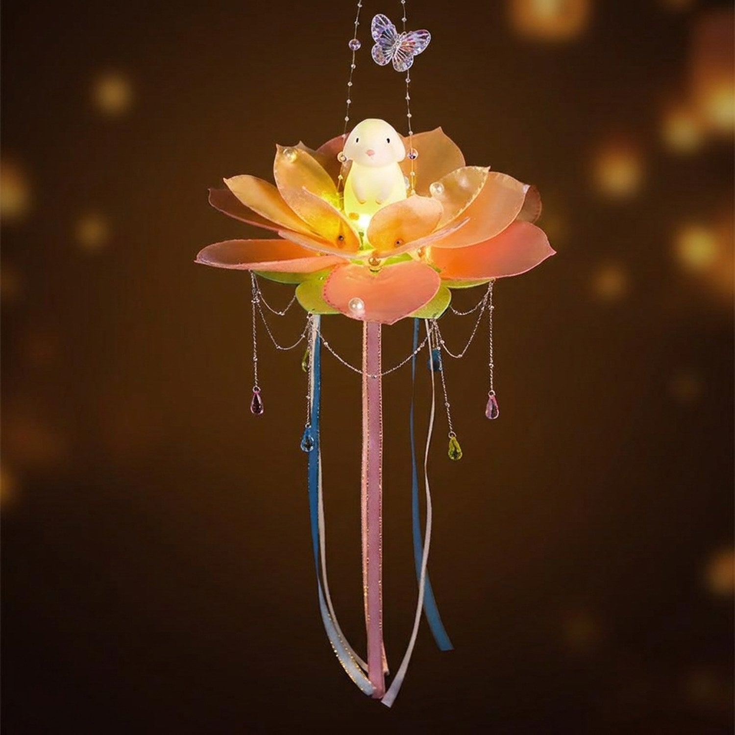 Lanterne lotus orange avec figurine lapin illuminée