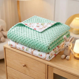 Couverture bébé pliée sur une commode avec doudou lapin et petite lampe