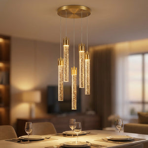 Lustre en cristal doré en cascade allumé au-dessus d'une table de salle à manger