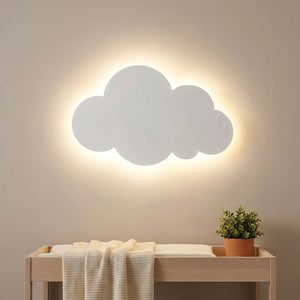 Applique nuage blanche allumée au dessus d'une table à langer dans une chambre de bébé