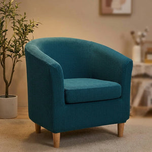 Housse de fauteuil cabriolet bleu petrole dans un salon avec plante