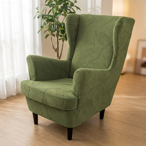 Fauteuil bergère vert à motif jacquard près d'une fenêtre avec plante
