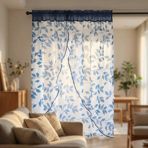 Voilage feuilles bleu dans un salon chaleureux avec canapé et coussins