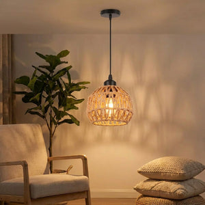 Suspension en corde de chanvre beige éclairant un coin salon bohème avec fauteuil et plante