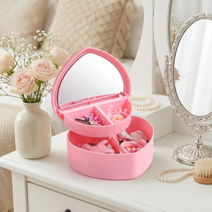 Boîte à bijoux rose avec miroir dans un coin coiffeuse