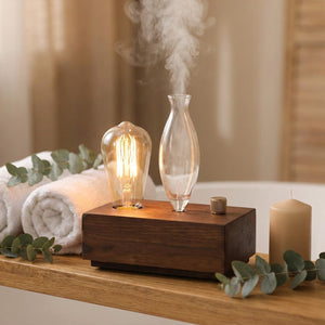 Diffuseur d'huile essentielle dans une salle de bain spa avec serviettes et eucalyptus