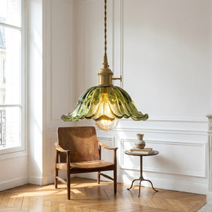 Suspension florale en verre vert dans salon parisien lumineux parquet bois fauteuil vintage