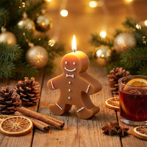 Bougie aromathérapie pain d'épice allumée sur table en bois avec pommes de pin et cannelle décoration Noël