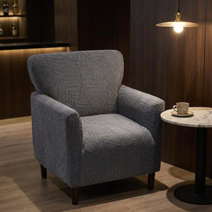 Housse de fauteuil club gris foncé dans un salon de bar cosy