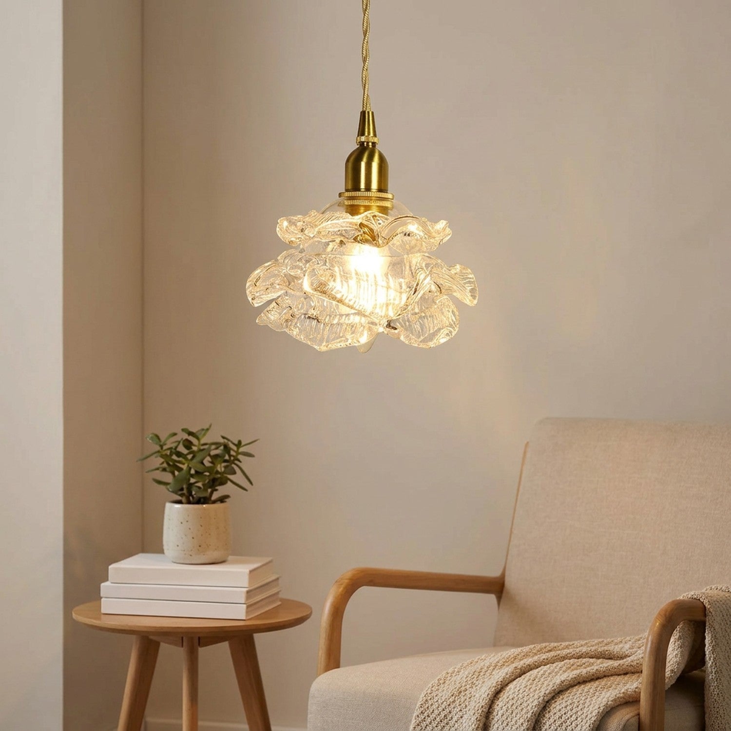 Suspension rose en verre nordique allumée dans un coin lecture avec fauteuil beige
