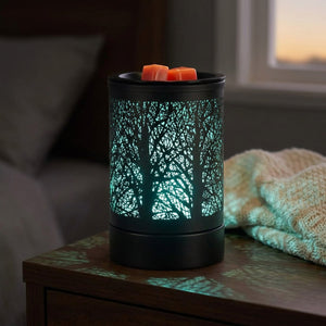 Brûle-parfum électrique noir sur une table de chevet avec lumière turquoise le soir