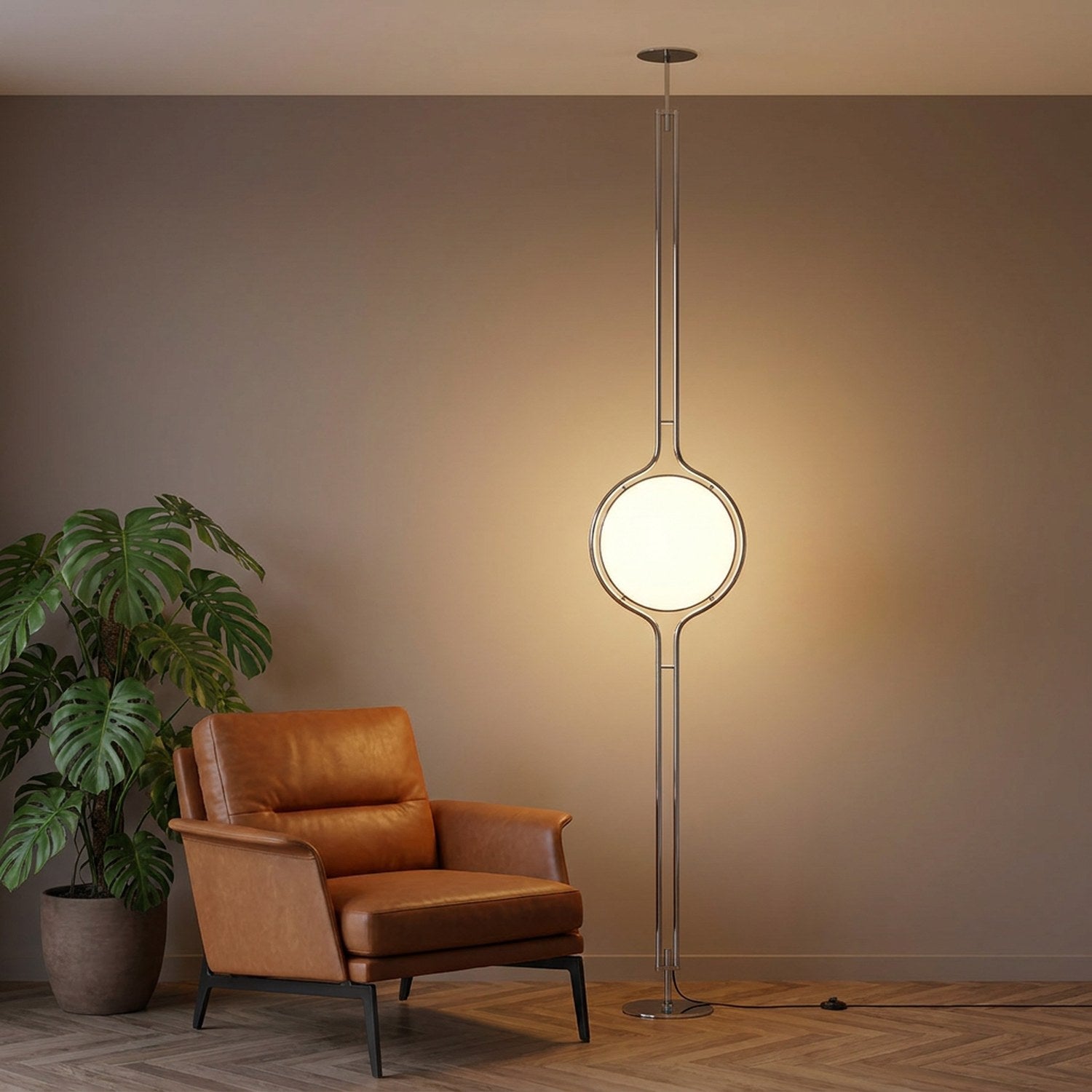 Lampadaire colonne chrome à boule lumineuse près d'un fauteuil en cuir et d'une plante