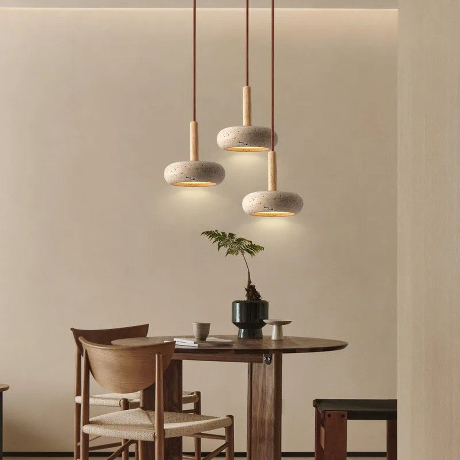 Suspensions travertin style Wabi Sabi au-dessus d'une table élégante