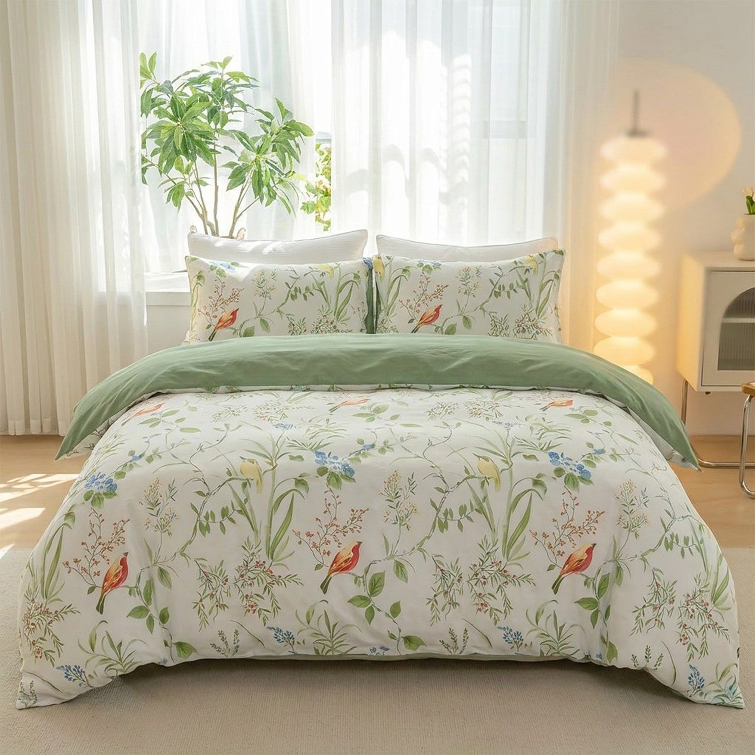 Parure de lit fleurie au motif botanique et oiseaux installée sur un lit dans une chambre lumineuse