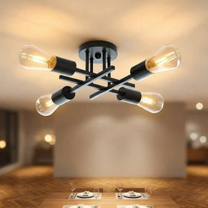 Lustre Sputnik métal noir 4 bras allumé installé au plafond d'une salle à manger moderne