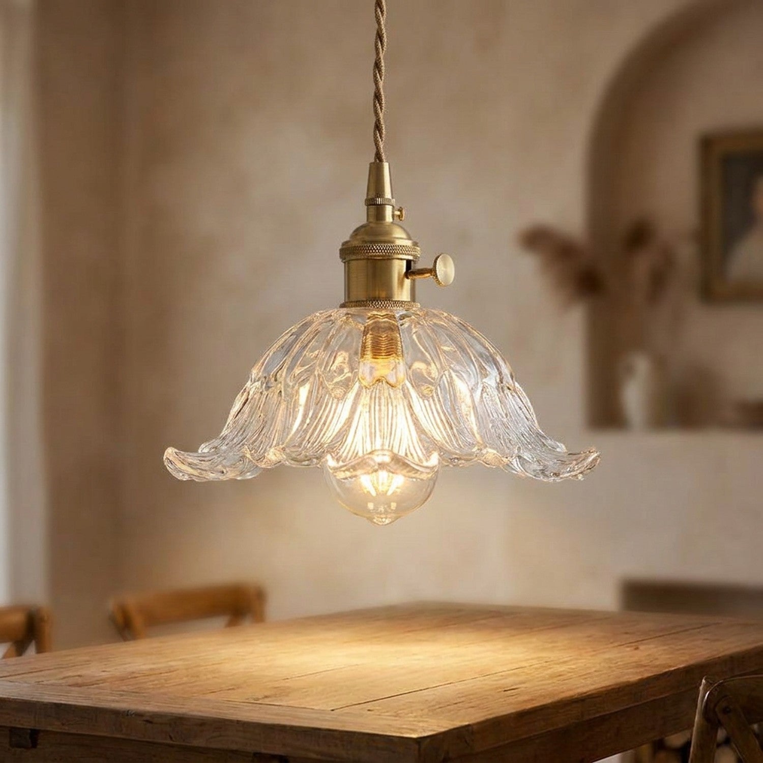 Suspension florale en verre transparent design vintage avec laiton doré éclairée au-dessus d'une table