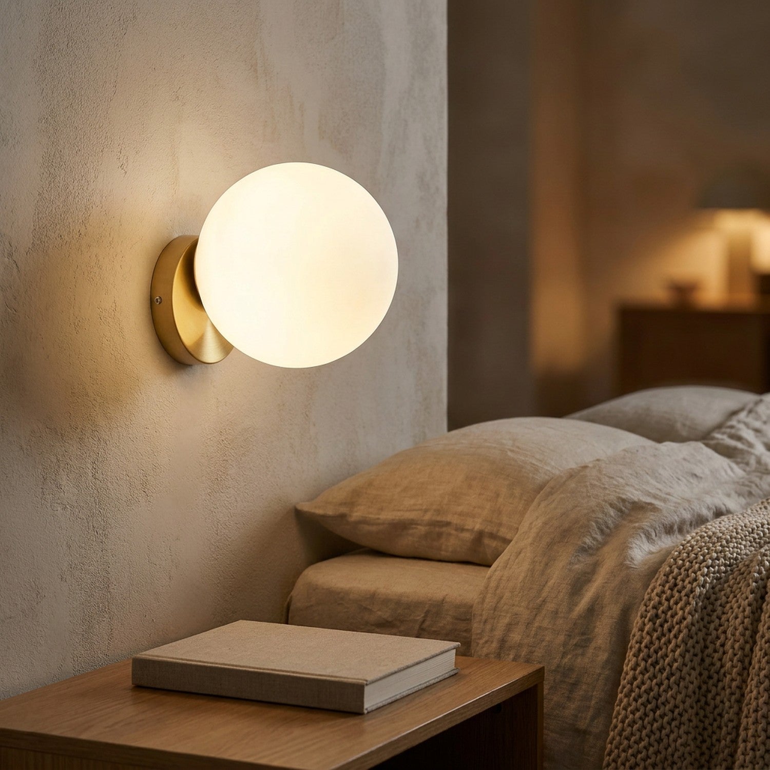 Applique murale boule de verre dorée diffusant une lumière chaude dans une chambre