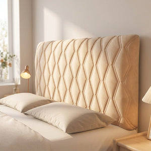 Housse de tête de lit capitonnée en velours beige sur un lit dans une chambre chaleureuse