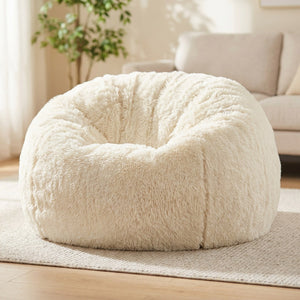 Pouf géant en fausse fourrure blanche posé au sol dans un salon lumineux et cosy