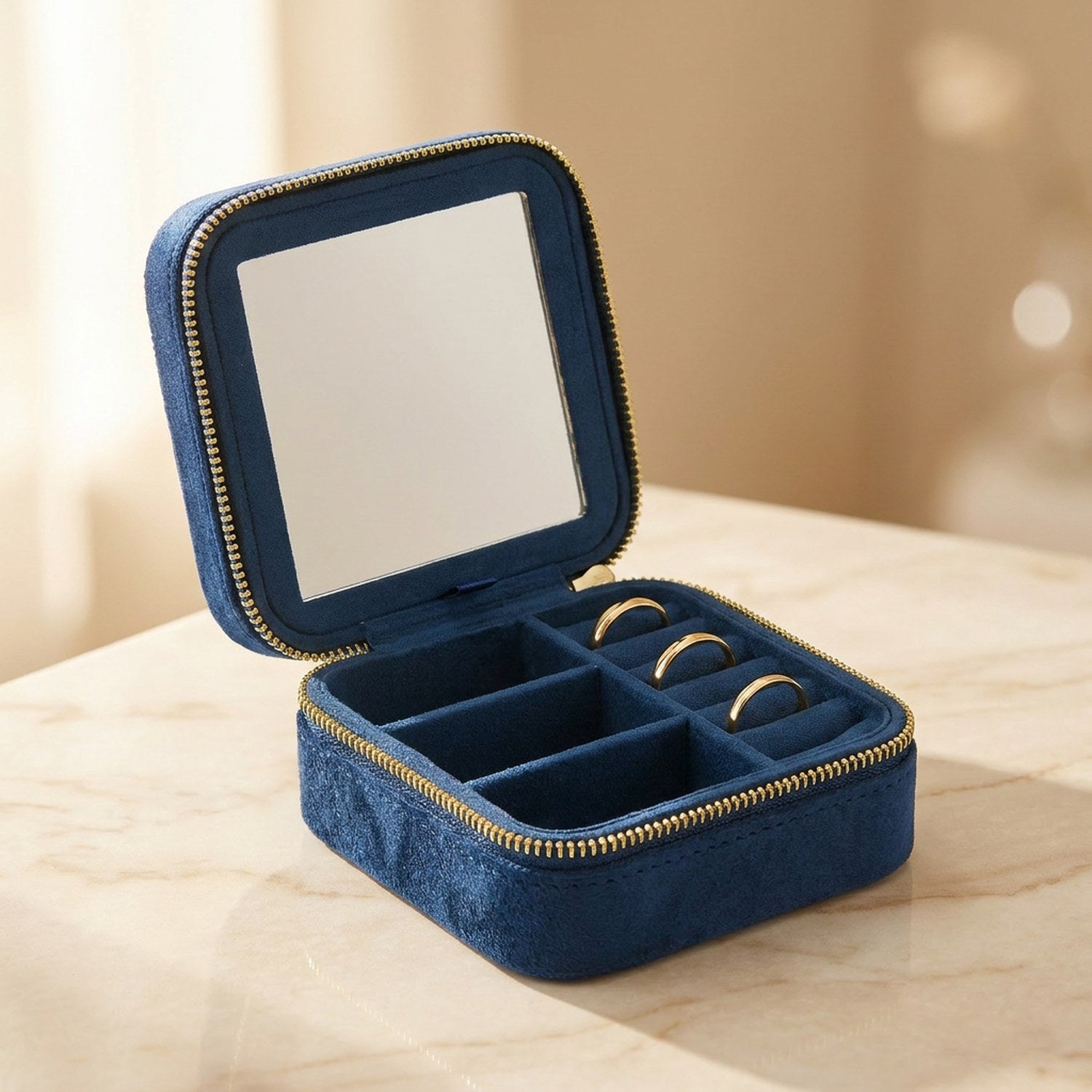 Boîte à bijoux de voyage en velours bleu marine ouverte avec miroir intérieur