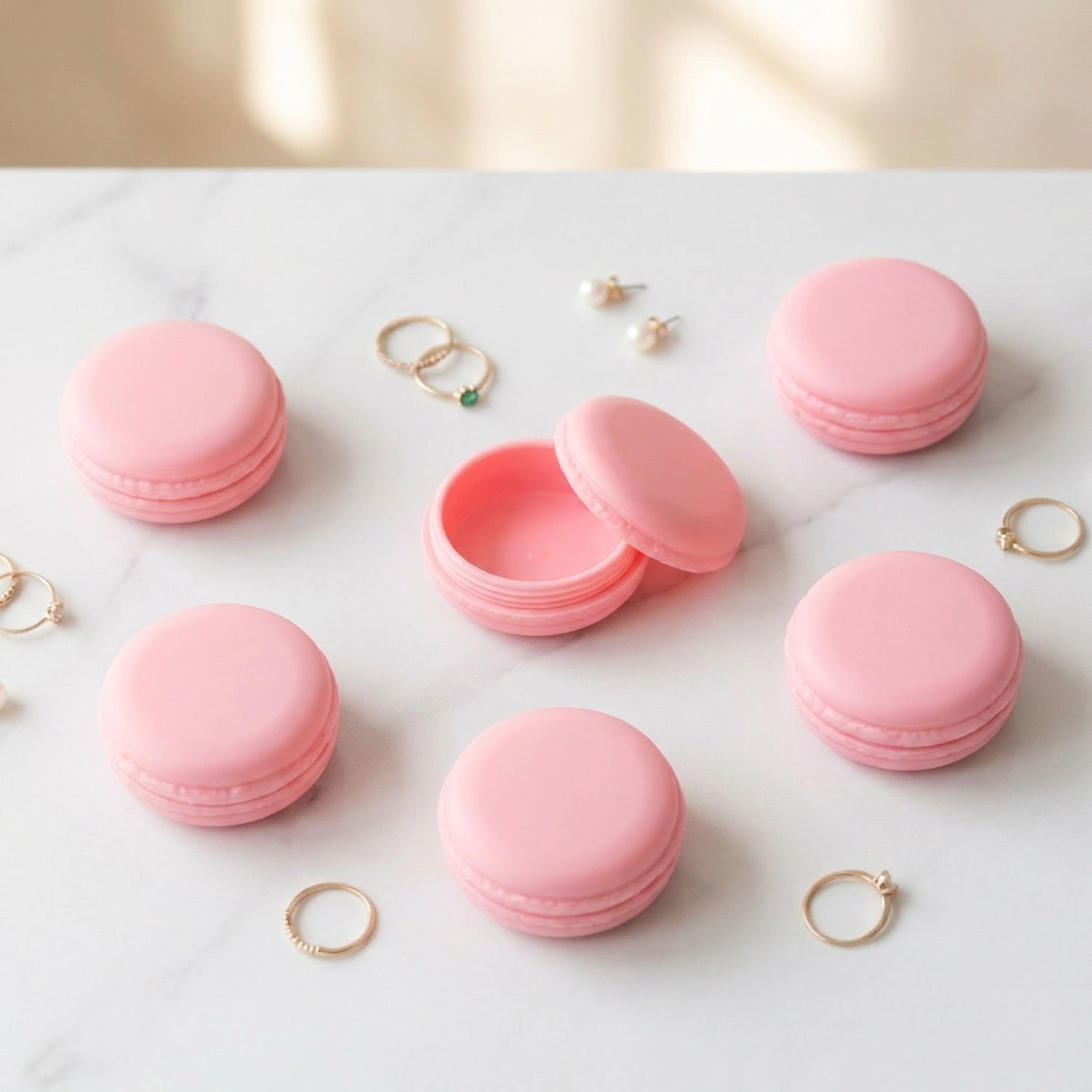 Lot de six boîtes à bijoux macaron rose pastel dont une ouverte sur fond marbre