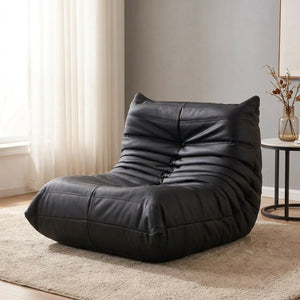 Pouf géant canapé de sol noir en simili cuir posé au sol