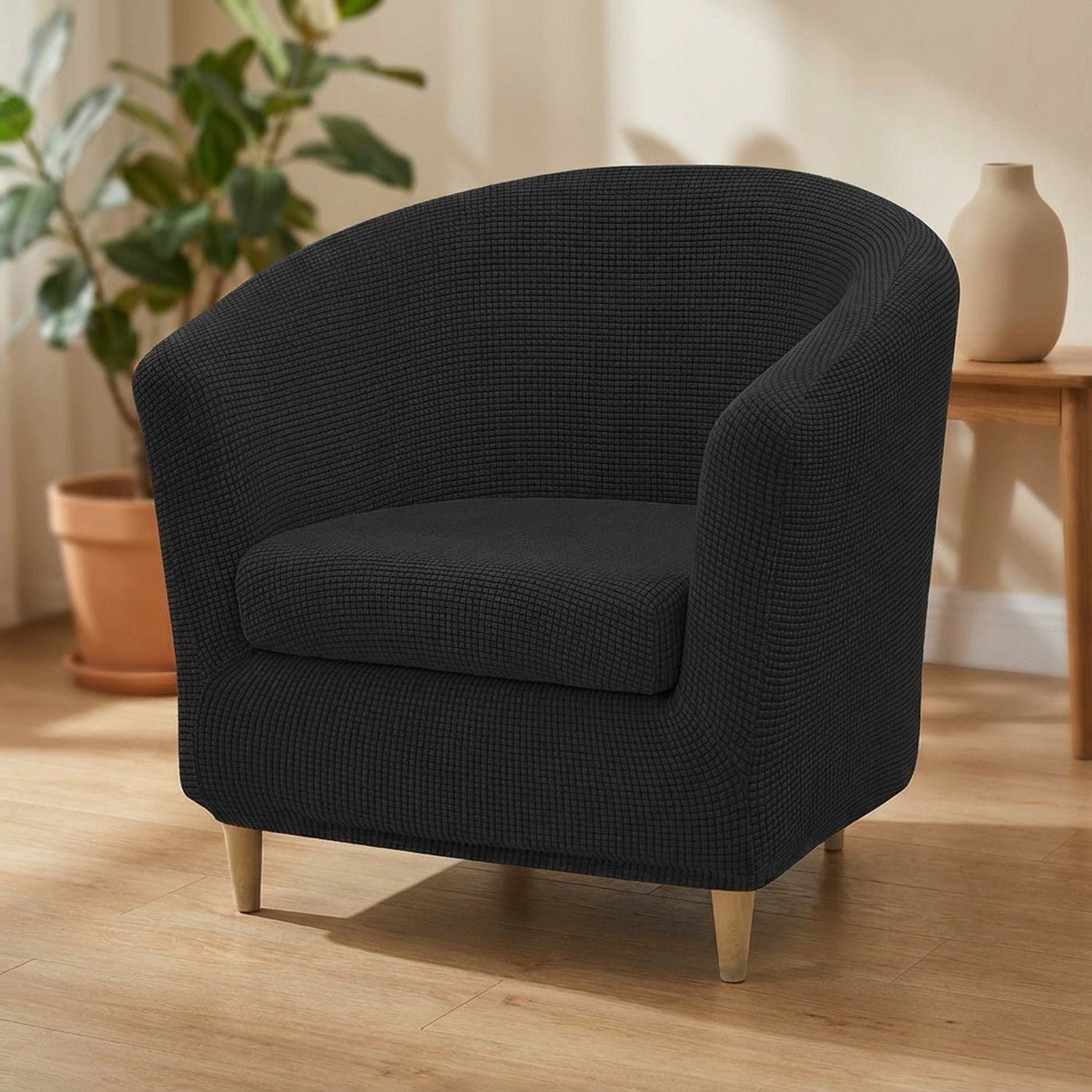 Housse de fauteuil club en jacquard noir sur un fauteuil arrondi