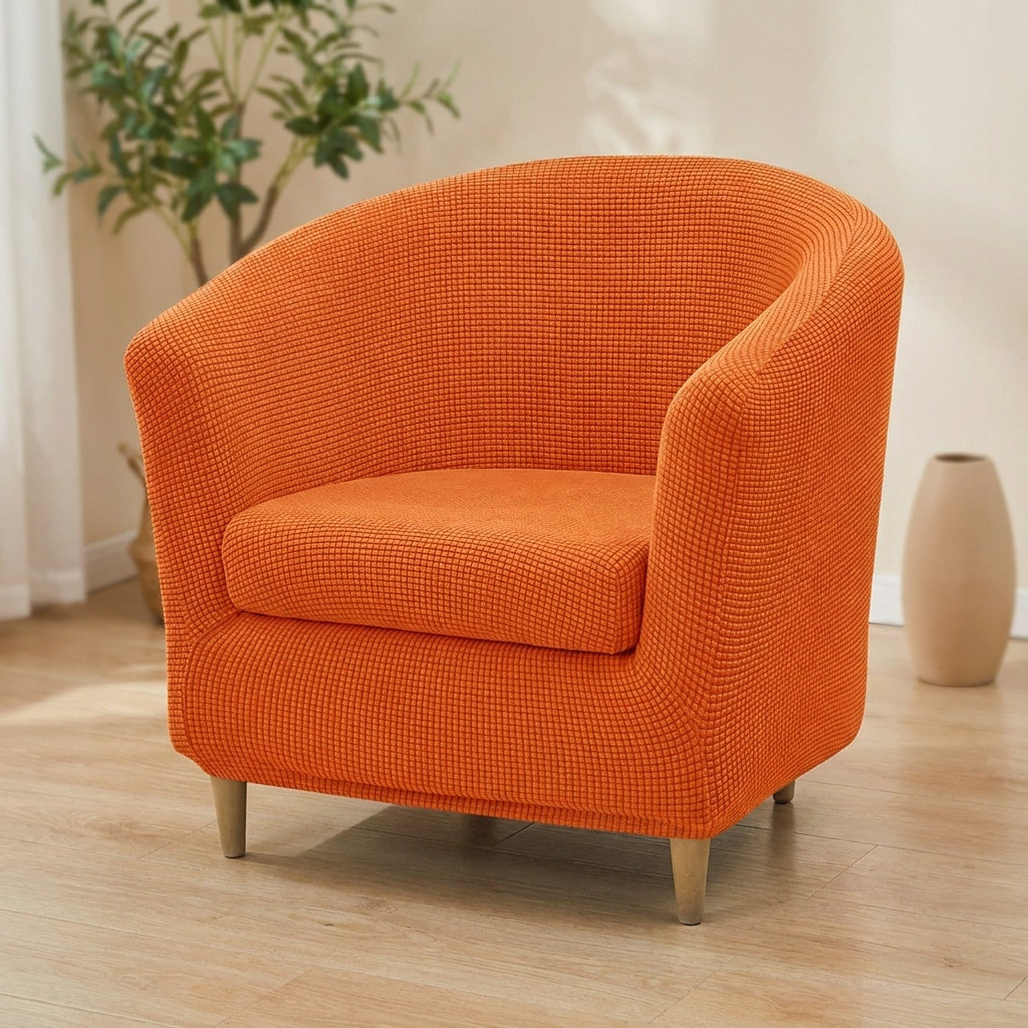 Housse de fauteuil club en jacquard orange sur un fauteuil arrondi