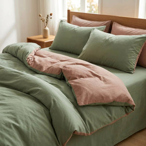 Parure de lit en coton lavé vert sauge et rose installée sur un lit dans une chambre chaleureuse