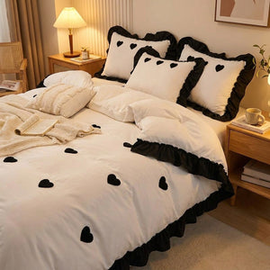 Parure de lit brodee coeur noir dans une chambre moderne avec lampe de chevet chaleureuse