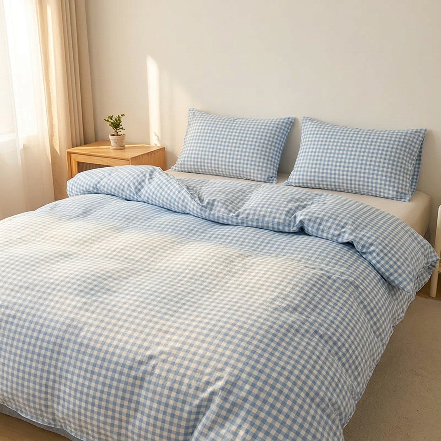 Parure de lit à carreaux vichy bleus sur un lit fait dans une chambre lumineuse