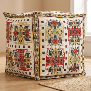 Pouf marocain housse écru et rouge à motifs aztèques vu de trois quarts