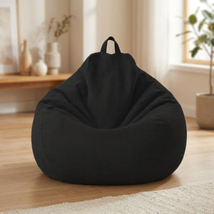 Pouf poire en coton lin noir posé au sol dans un intérieur cosy