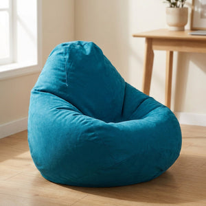 Pouf paresseux tatami bleu canard posé dans un coin bureau lumineux