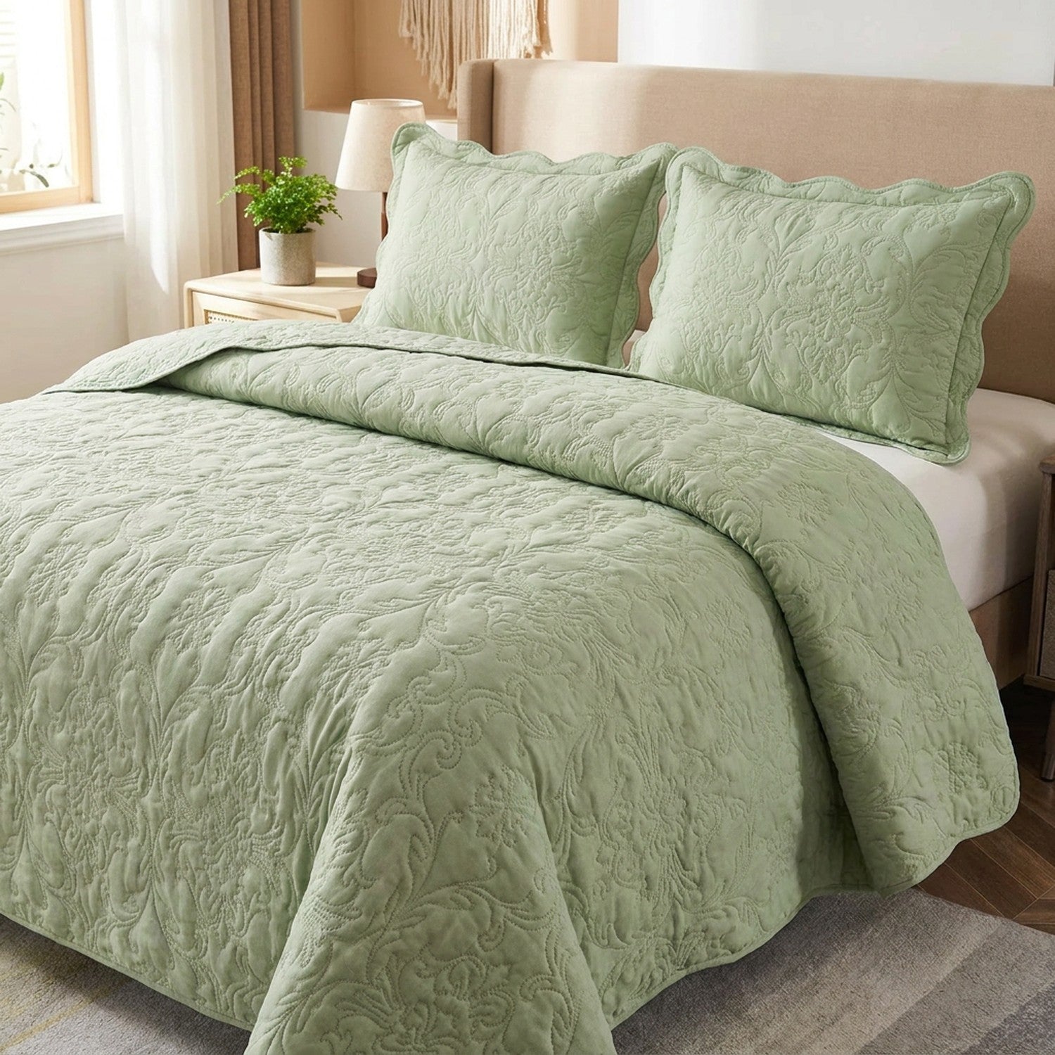 Couvre-lit matelasse vert sauge au motif damasse sur un lit avec deux taies assorties