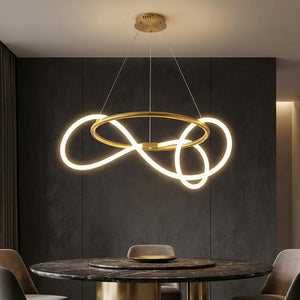Suspension anneau LED dorée au-dessus d'une table ronde en marbre sombre