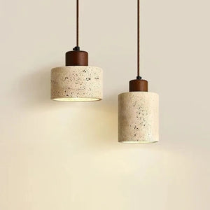 Suspension travertin noyer modèles Disque et Cylindre allumés fond beige