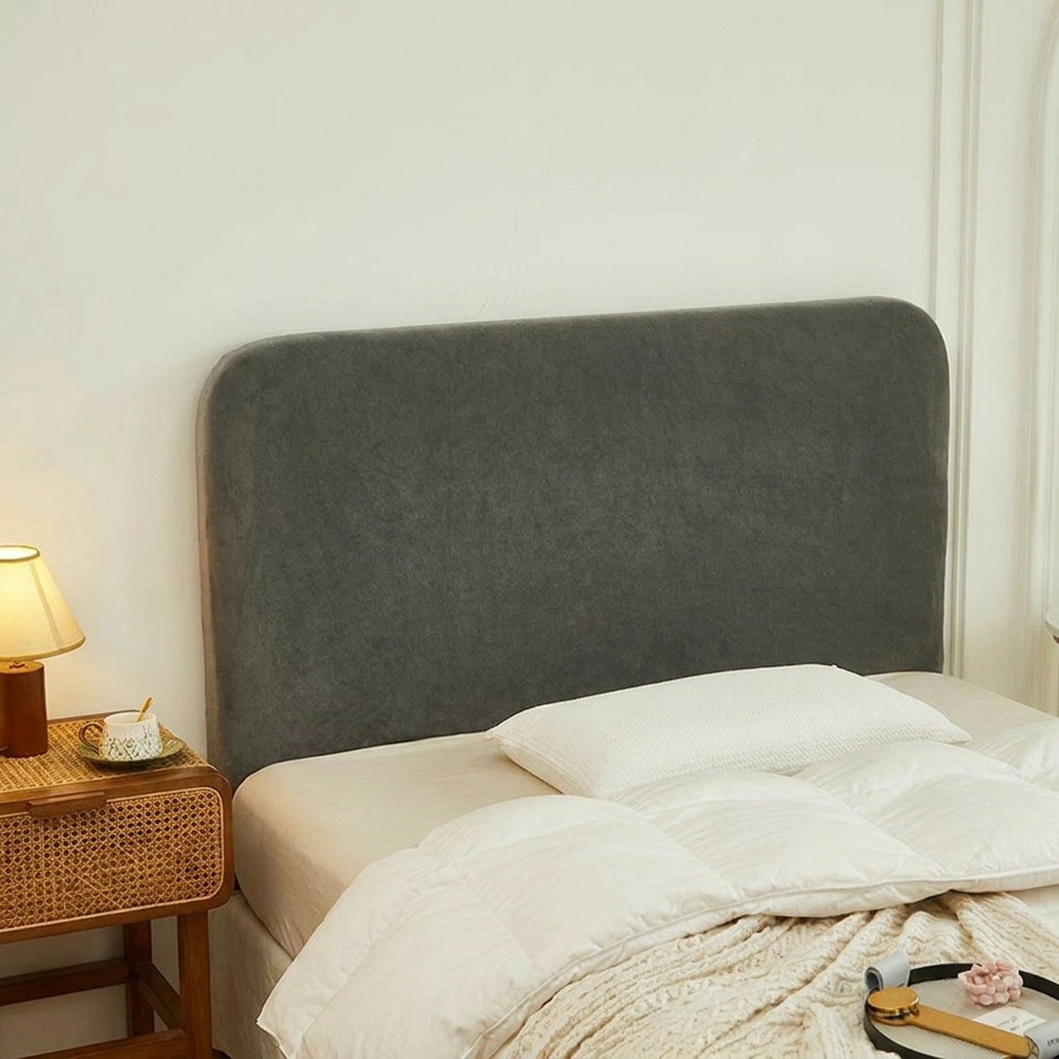 Housse de tête de lit gris foncé en velours installée dans une chambre