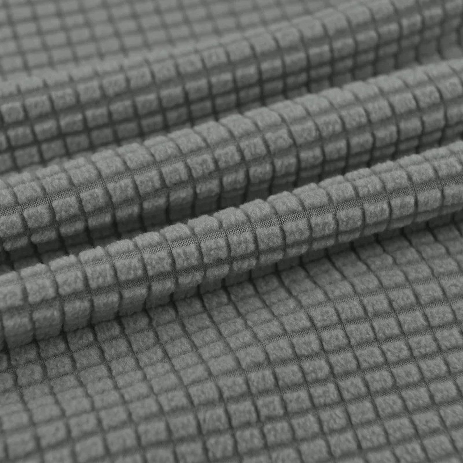 Gros plan sur le tissu tricoté doux et texturé de la housse de chaise