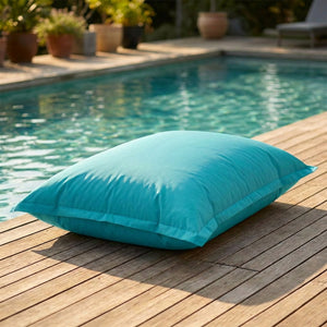 Pouf géant d'extérieur turquoise au bord d'une piscine