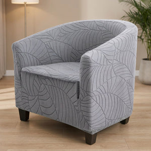 Fauteuil club avec housse grise à motif feuilles jacquard